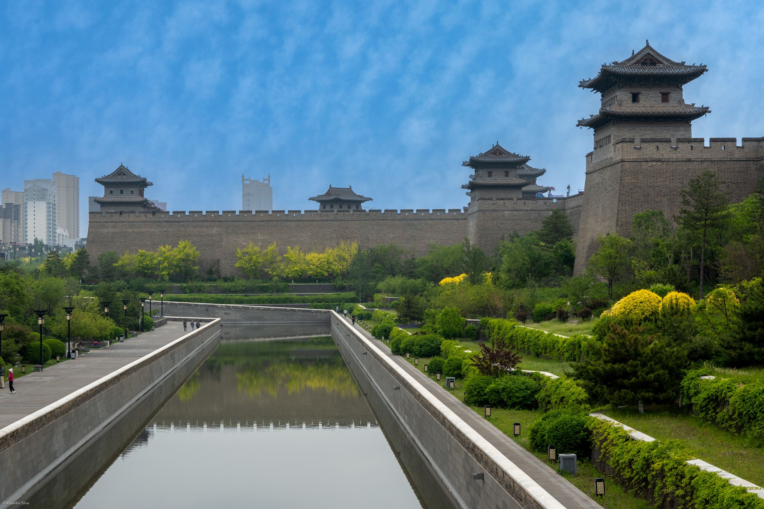 The rebuilt Ming city wall of Datong with its gate towers under a blue sky