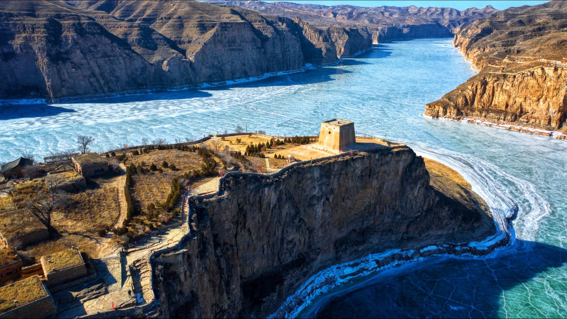 A Ming watchtower on the cliff edge above the frozen Yellow River at Laoniuwan