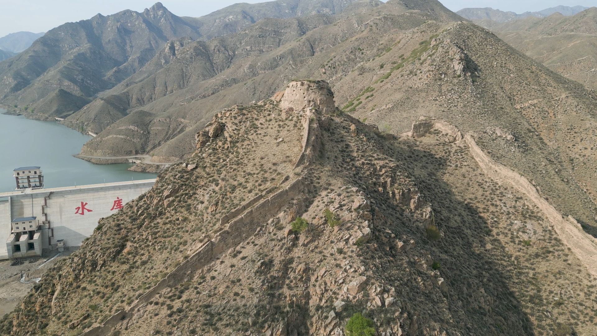 The rammed-earth Great Wall climbing a bare ridge at Shoukoubu