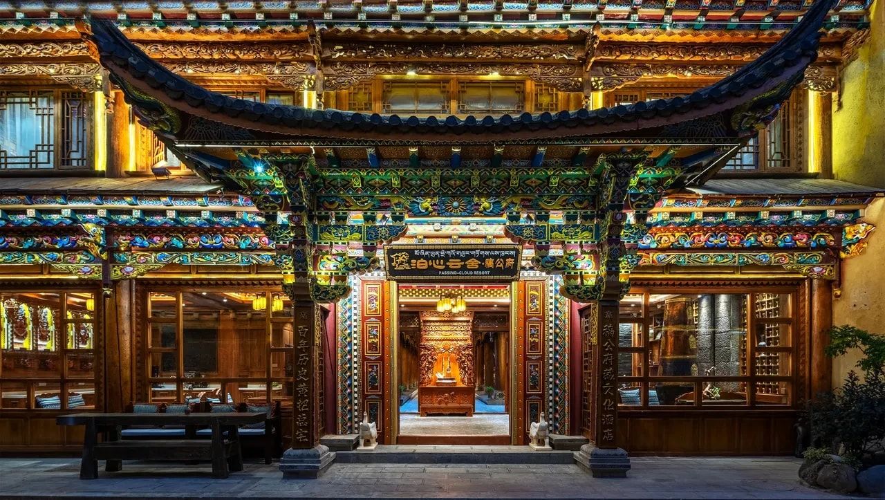 The carved and painted gate of Passing-cloud Resort · Gaogongfu at dusk, in Shangri-La's old town