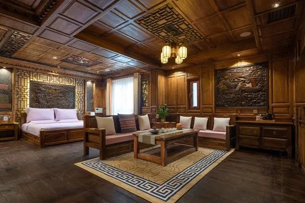 A suite at Gaogongfu: carved wooden walls and ceiling, a large bed and a sitting area